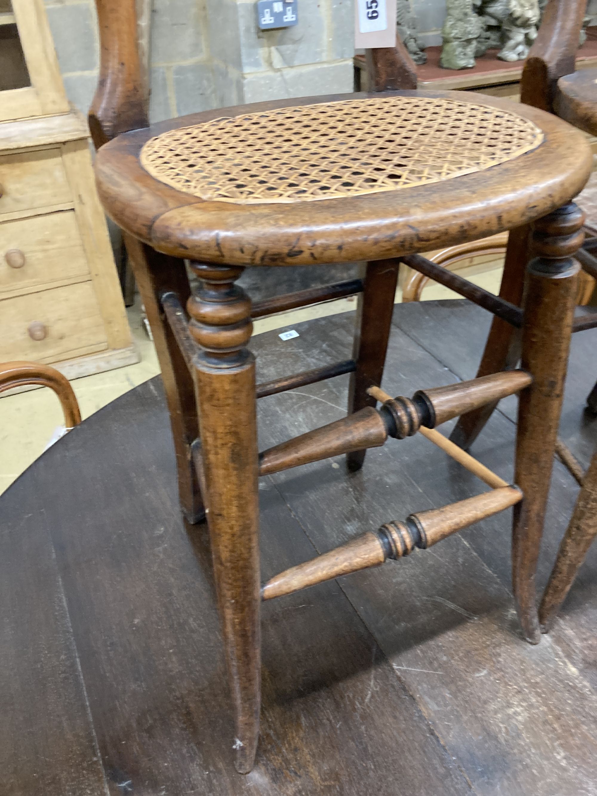 A pair of Victorian spindle back cane seat correction chairs